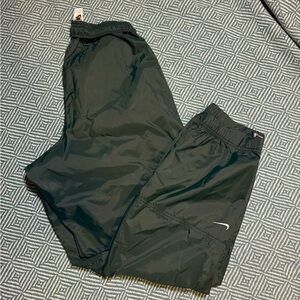dark green Nike track windbreaker pants